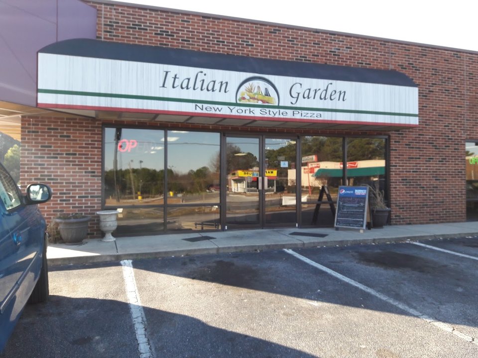 Italian restaurant dining room with simple tables and chairs.