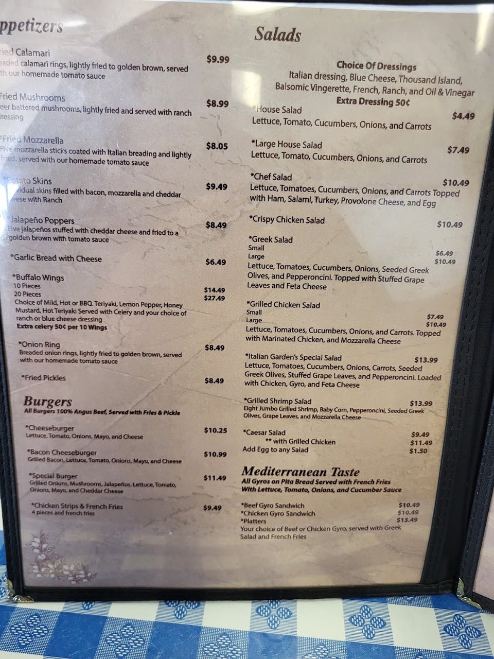 Printed menu showing Italian dishes and sandwiches.